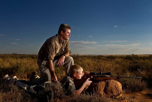 Man in Orania, South Africa, teaches his son how to shoot..jpeg