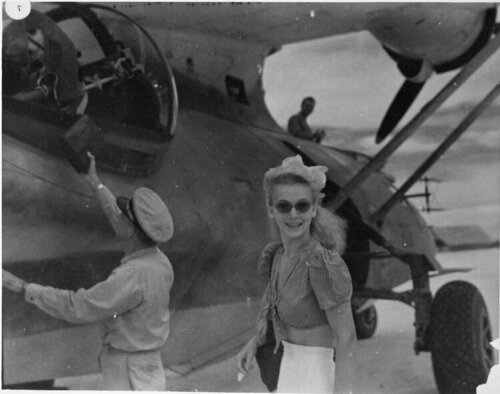 Navy nurse boarding a PBY on Saipan, heading for Guam and thence points Japanward, 1945..jpeg