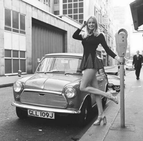 British model Jenny Clare posing next to her Mini. London, 1972.jpg
